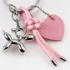 A silver balloon dog-shaped keychain paired with a colorful knot-shaped heart-shaped tag Application Scenario
